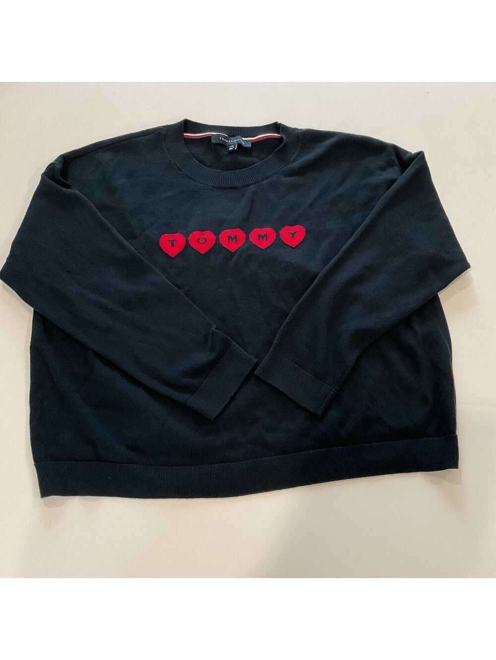black knit sweater featuring an embroidered red hearts Size Large